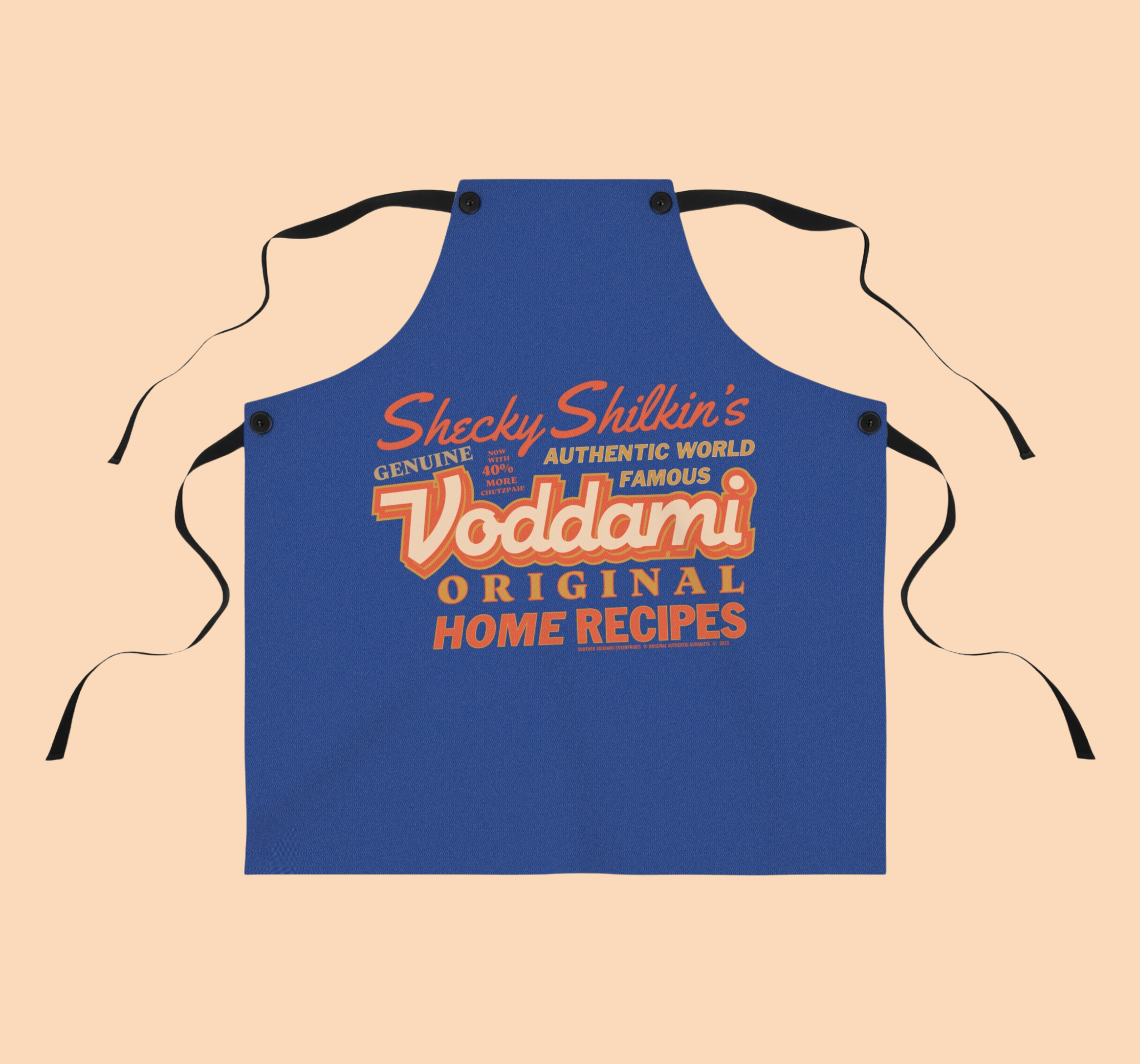 Blue apron with red and white Voddami brand text on a beige background